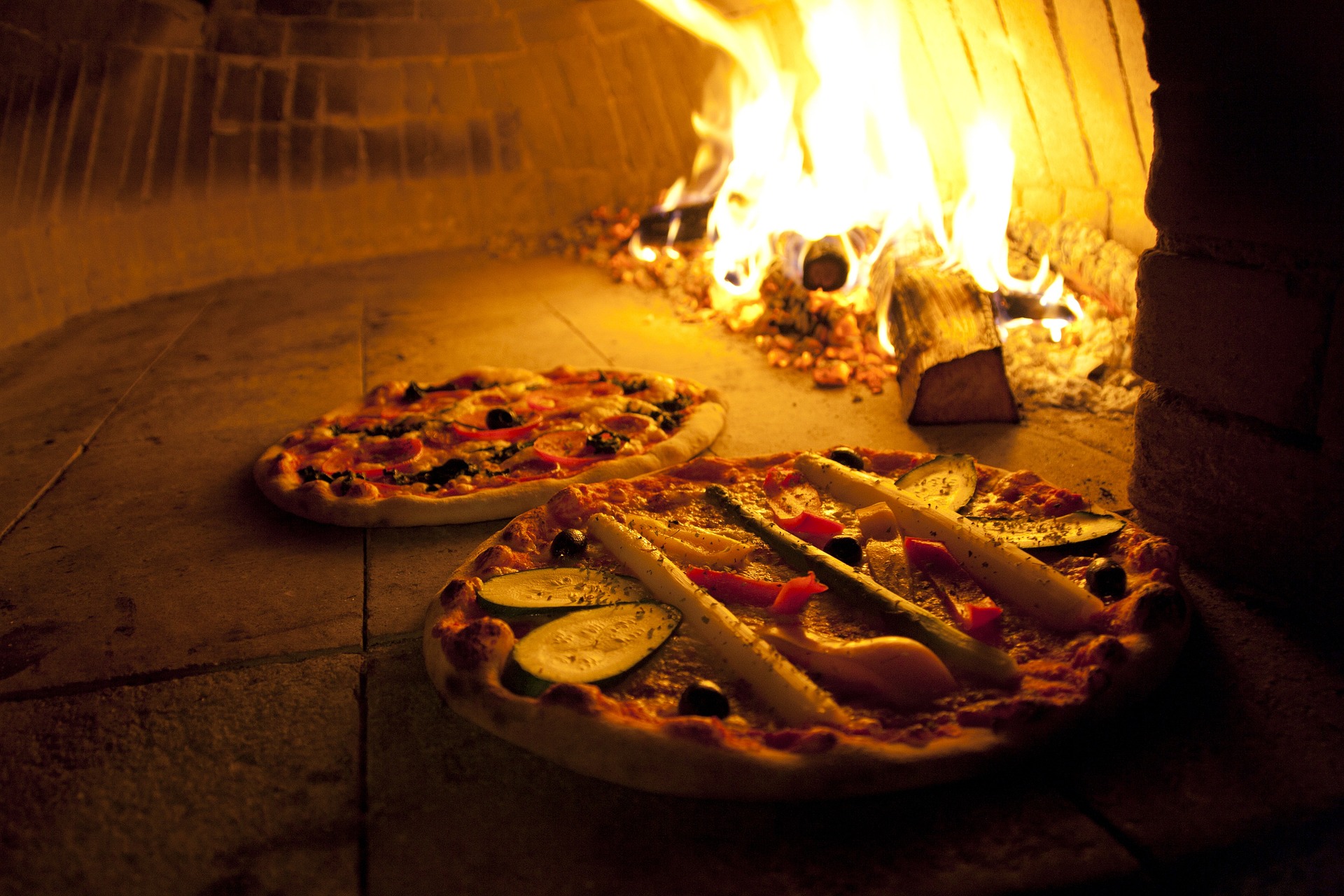 wood-fired neapolitan pizza being cooked in wood oven