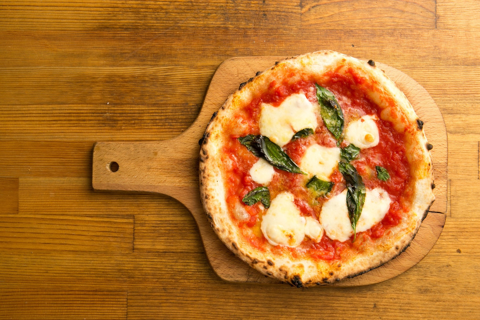 delicious margherita pizza on pizza peel